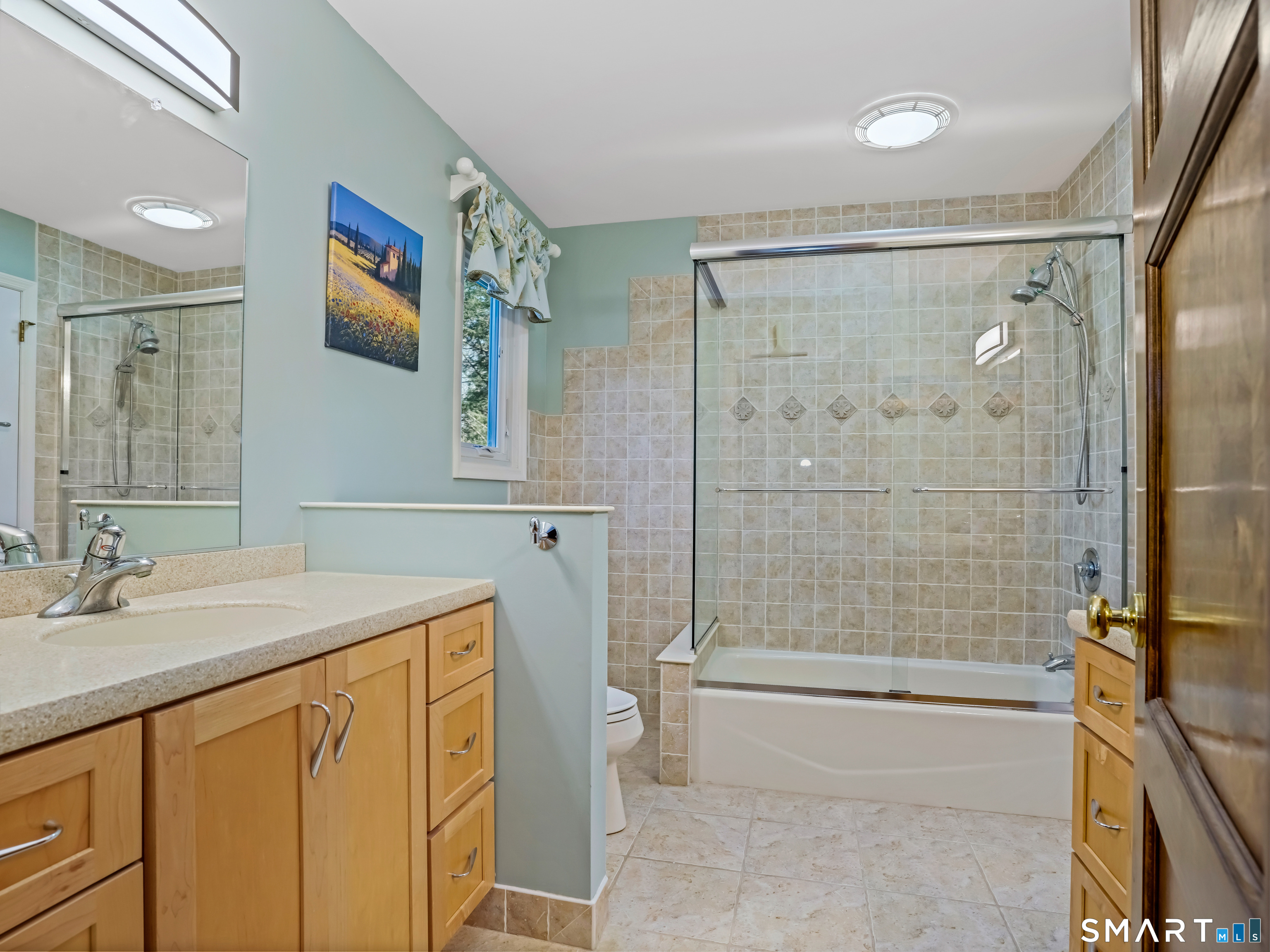 208 Cascade Road Stamford, CT 06903 - Photo 21 of 31 a bathroom with a granite countertop sink mirror bathtub and shower