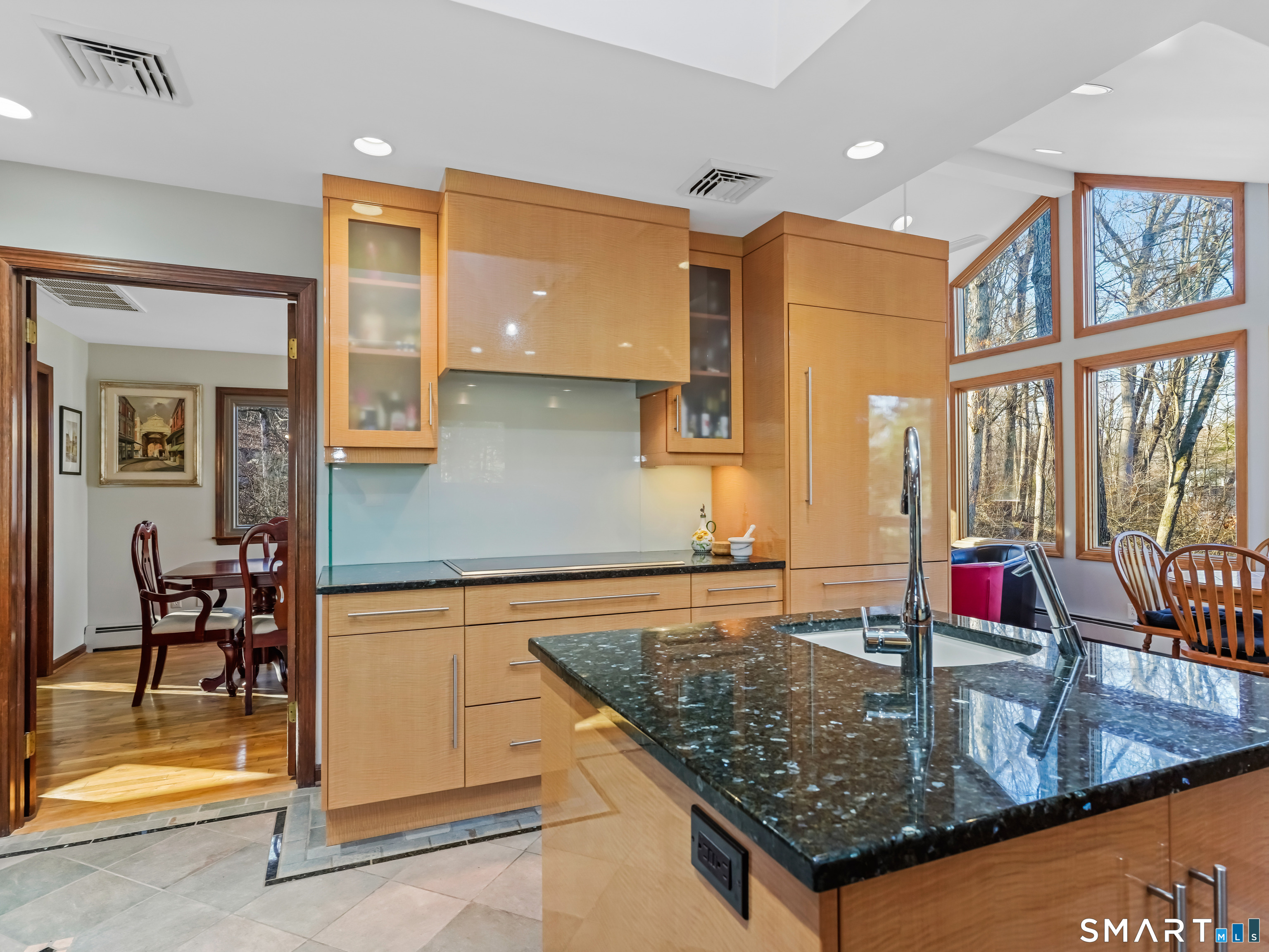 208 Cascade Road Stamford, CT 06903 - Photo 6 of 31 a kitchen with kitchen island granite countertop a stove a sink and a dining table