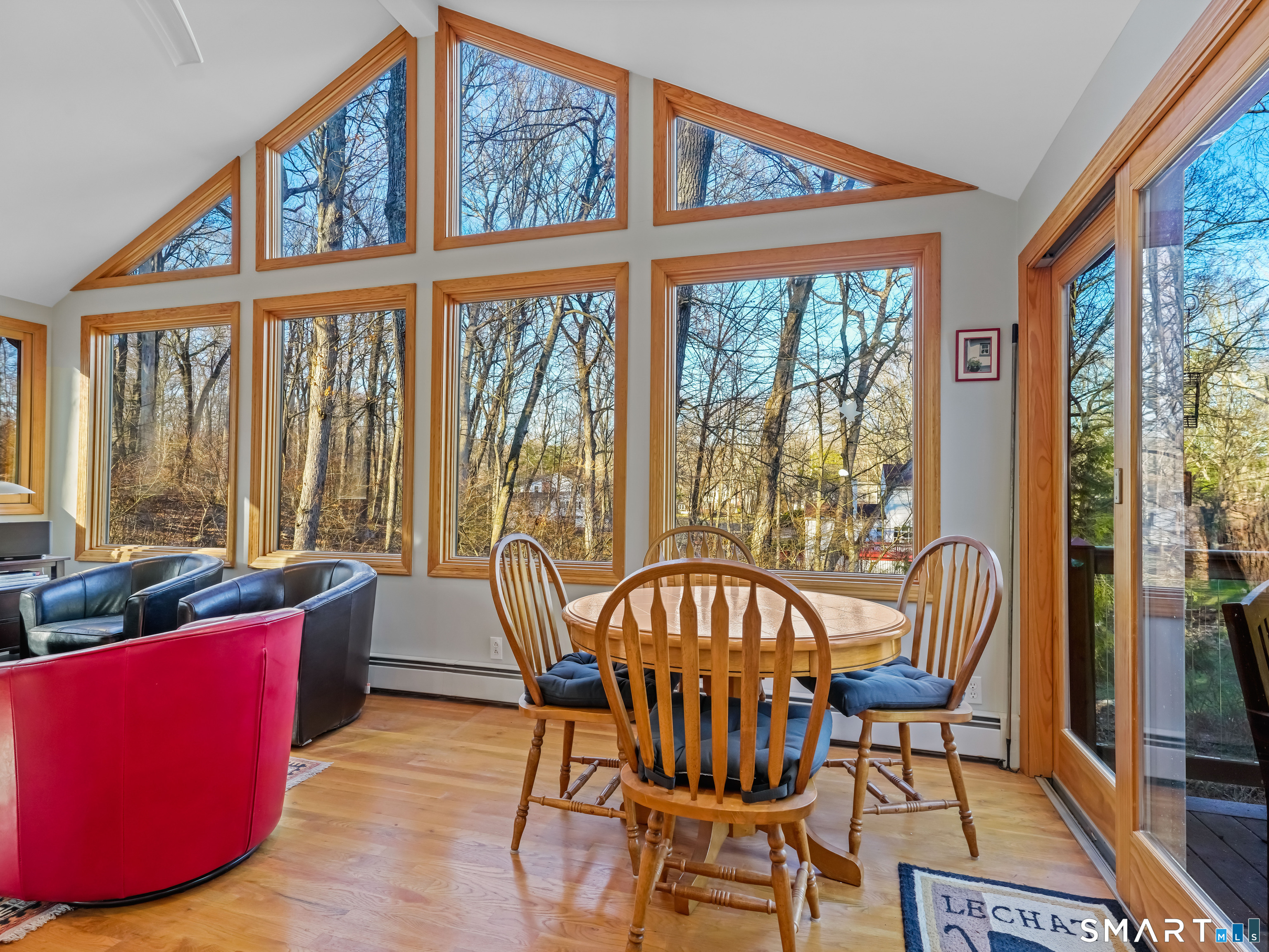 208 Cascade Road Stamford, CT 06903 - Photo 10 of 31 a view of a dining room with furniture large windows and wooden floor