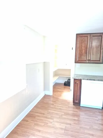 a view of a living room with a wooden floor