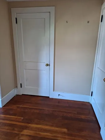 a view of room with wooden floor