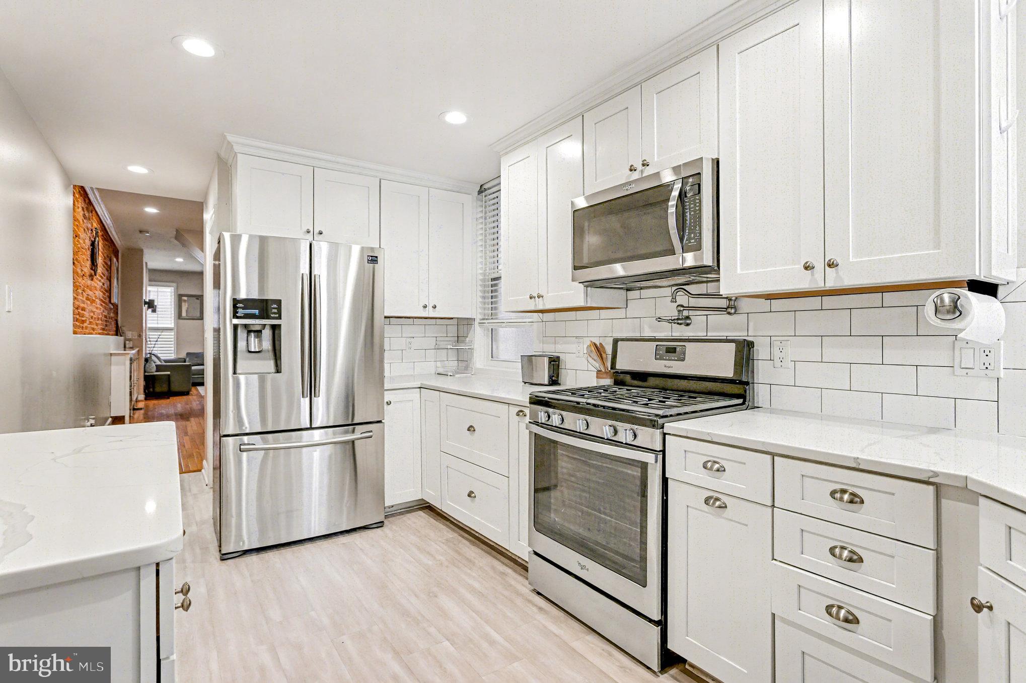 1314 South Hanover Street Baltimore, MD 21230 - Photo 11 of 30 a kitchen with stainless steel appliances a refrigerator stove and microwave