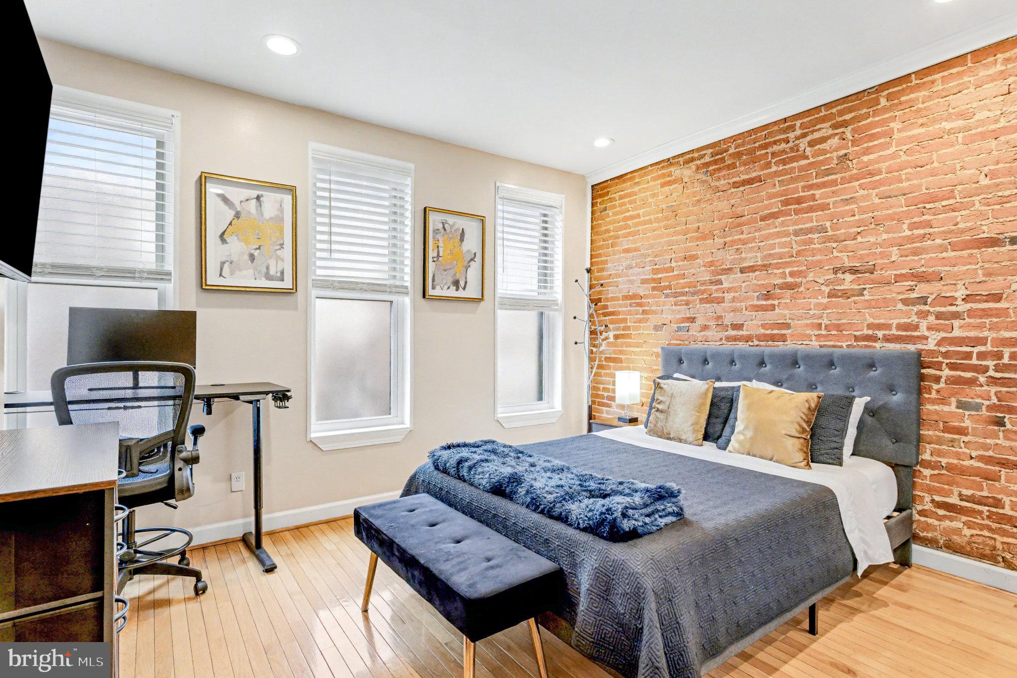 1314 South Hanover Street Baltimore, MD 21230 - Photo 16 of 30 a bedroom with a bed and a flat screen tv