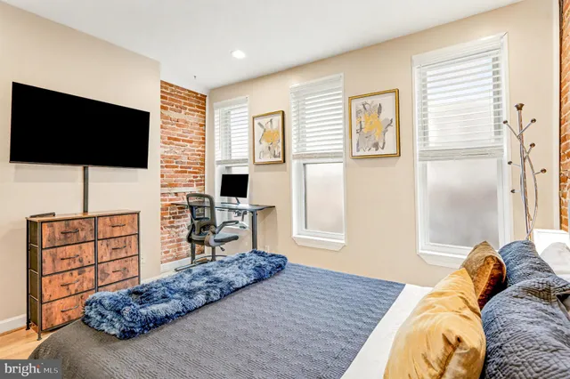 a bedroom with a bed and flat screen tv