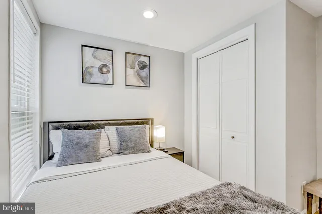 a bedroom with a bed and painting on the wall