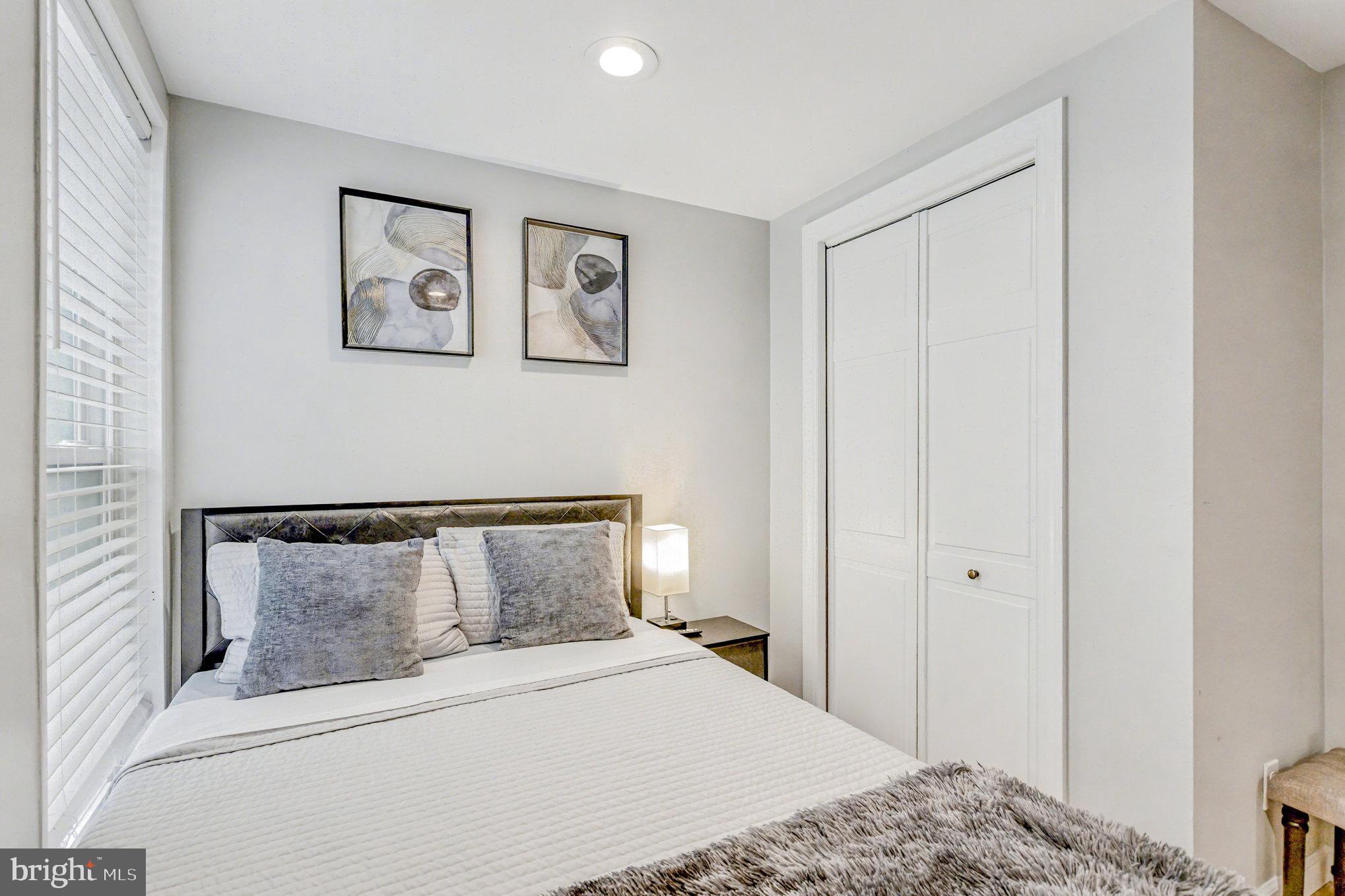 1314 South Hanover Street Baltimore, MD 21230 - Photo 19 of 30 a bedroom with a bed and painting on the wall