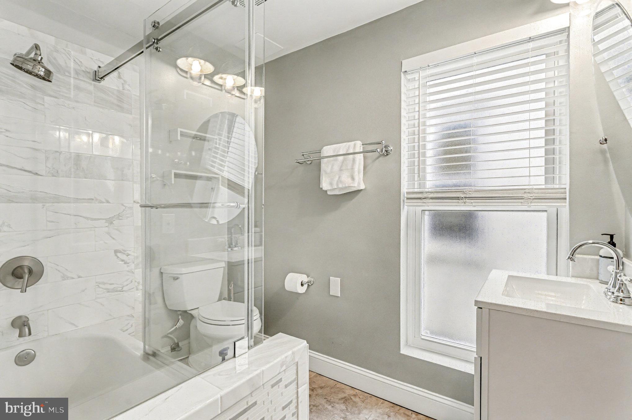 1314 South Hanover Street Baltimore, MD 21230 - Photo 20 of 30 a bathroom with a sink a toilet and shower