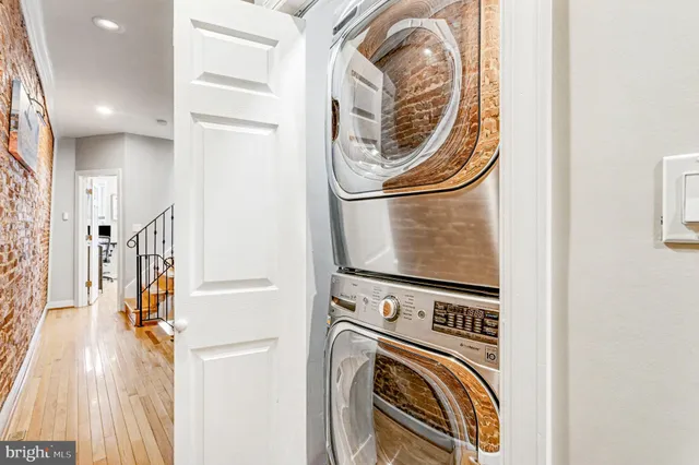 a view of a storage & utility room with a washer dryer