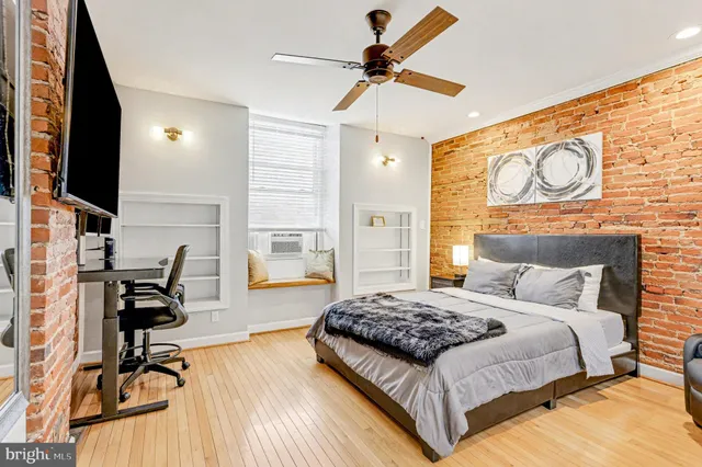 a bedroom with a bed and flat screen tv