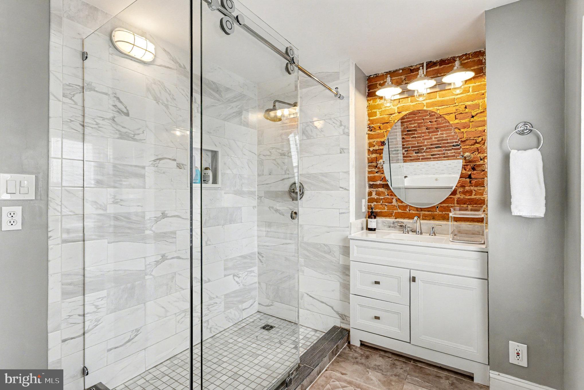 1314 South Hanover Street Baltimore, MD 21230 - Photo 26 of 30 a bathroom with a granite countertop sink a mirror and a shower