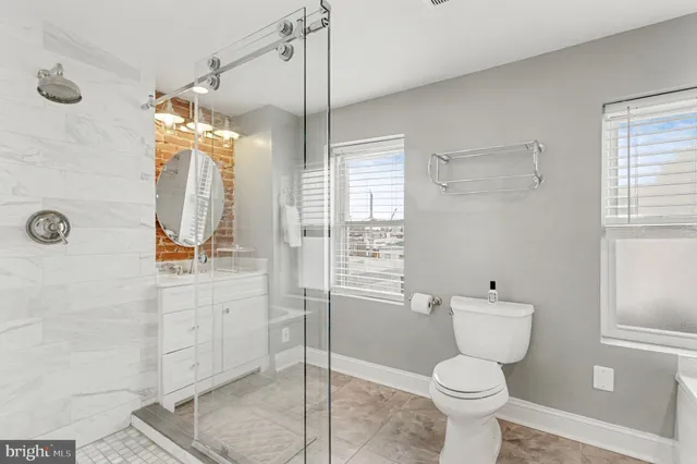a bathroom with a toilet sink and shower