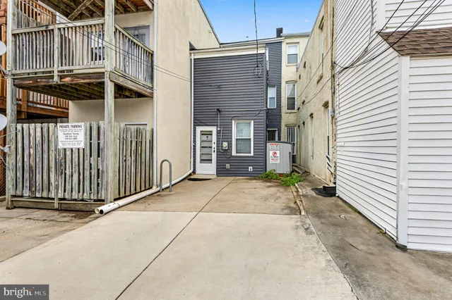 a view of a house with a small backyard