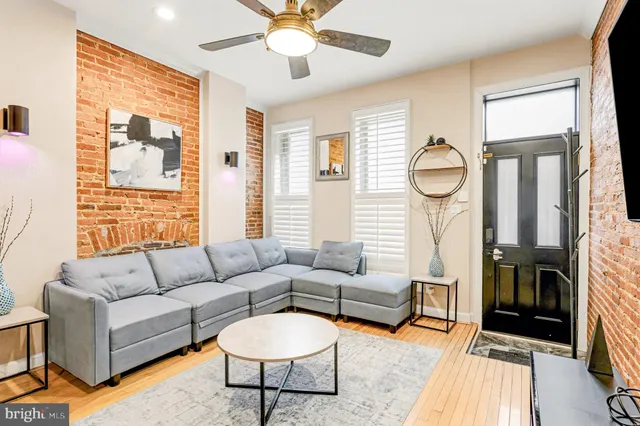 a living room with furniture a fireplace and a large window