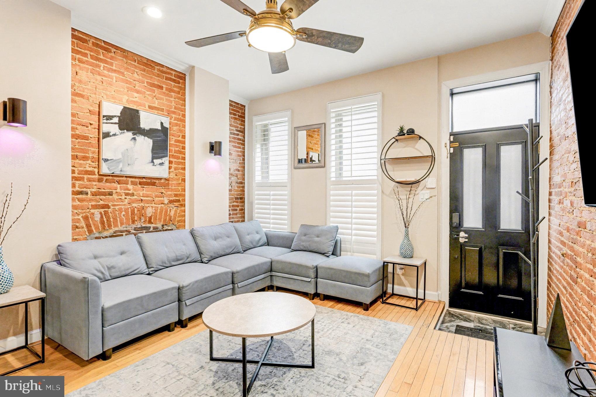 1314 South Hanover Street Baltimore, MD 21230 - Photo 3 of 30 a living room with furniture a fireplace and a large window
