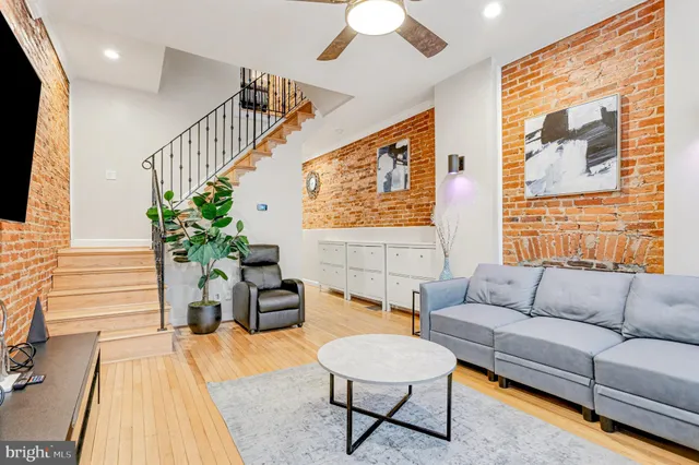 a living room with furniture and a potted plant