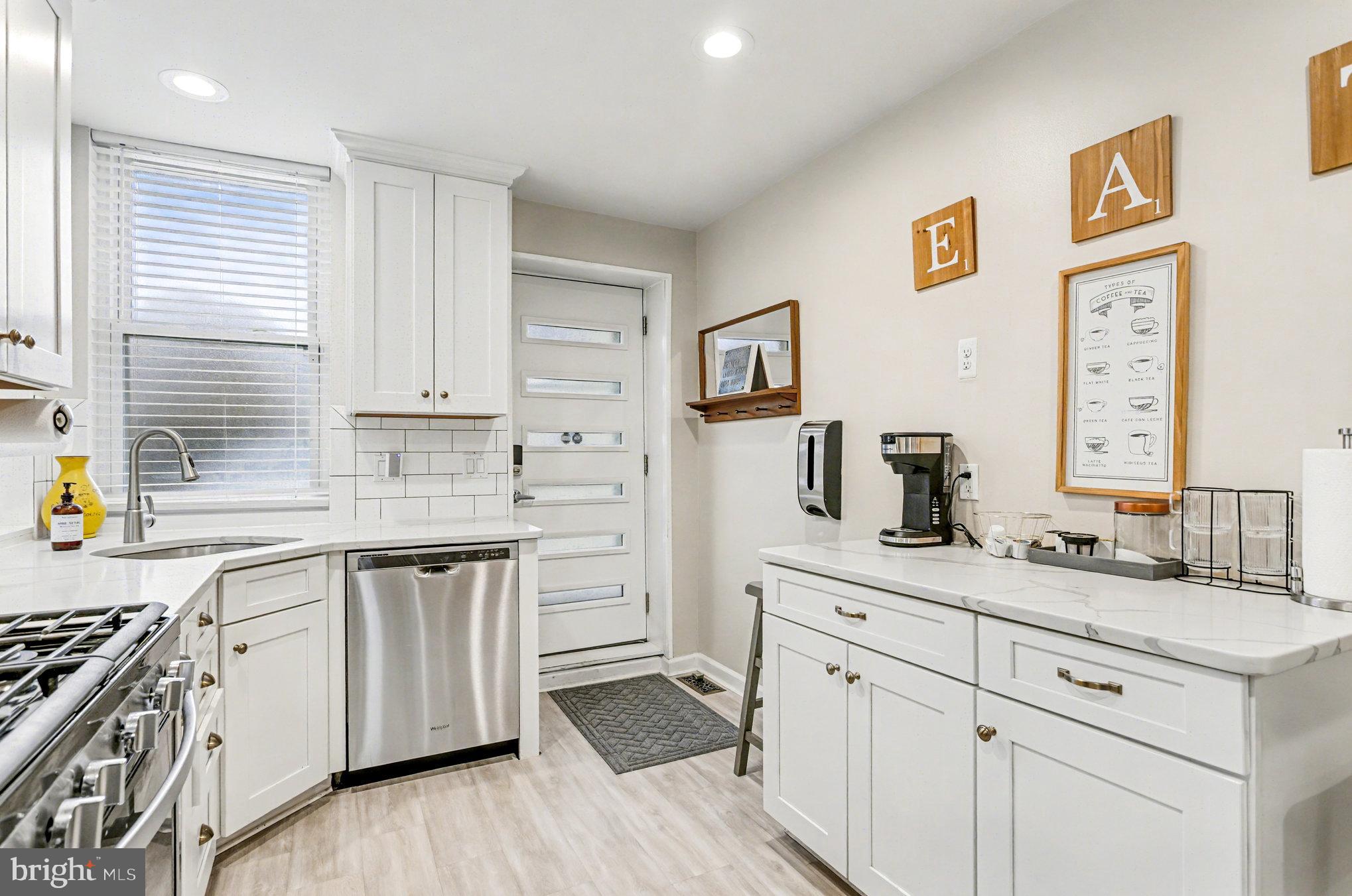 1314 South Hanover Street Baltimore, MD 21230 - Photo 9 of 30 a kitchen with stainless steel appliances granite countertop a sink cabinets and wooden floor
