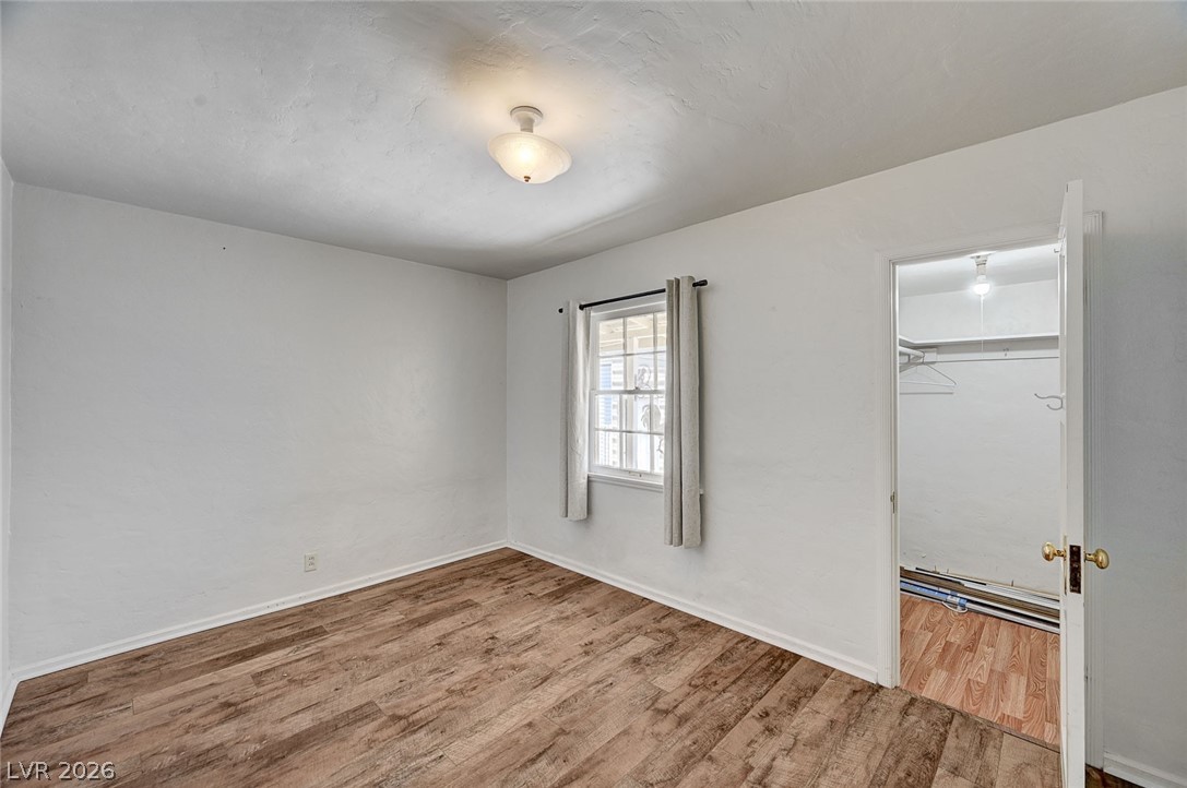 629 L Avenue Boulder City, NV 89005 - Photo 28 of 46 Bedroom with light wood-style floors and a walk in closet