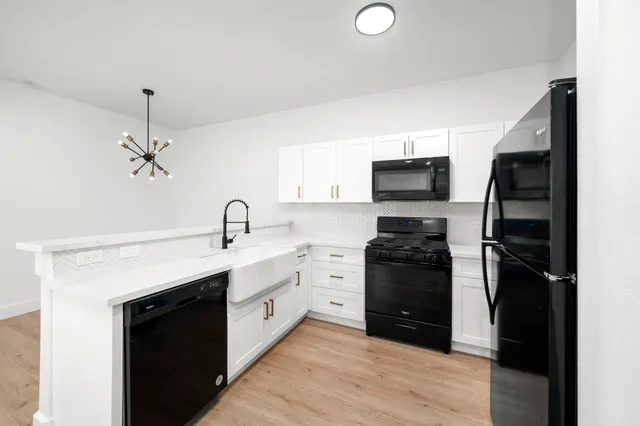 a kitchen with a sink stainless steel appliances and cabinets
