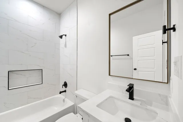 a view of a kitchen with a sink a ceiling fan and wooden floor
