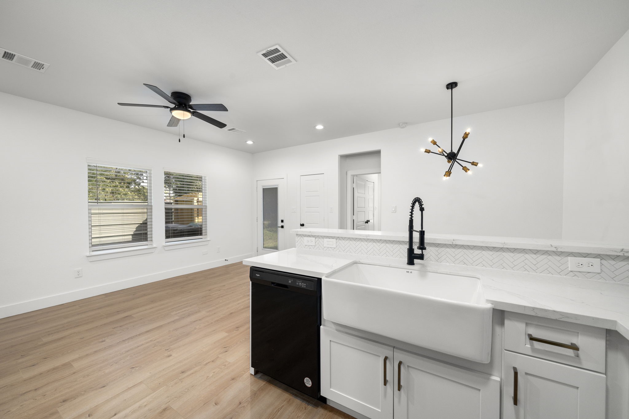 7205 Tippett Street, Unit B Houston, TX 77088 - Photo 3 of 15 a kitchen with a sink cabinets and wooden floor