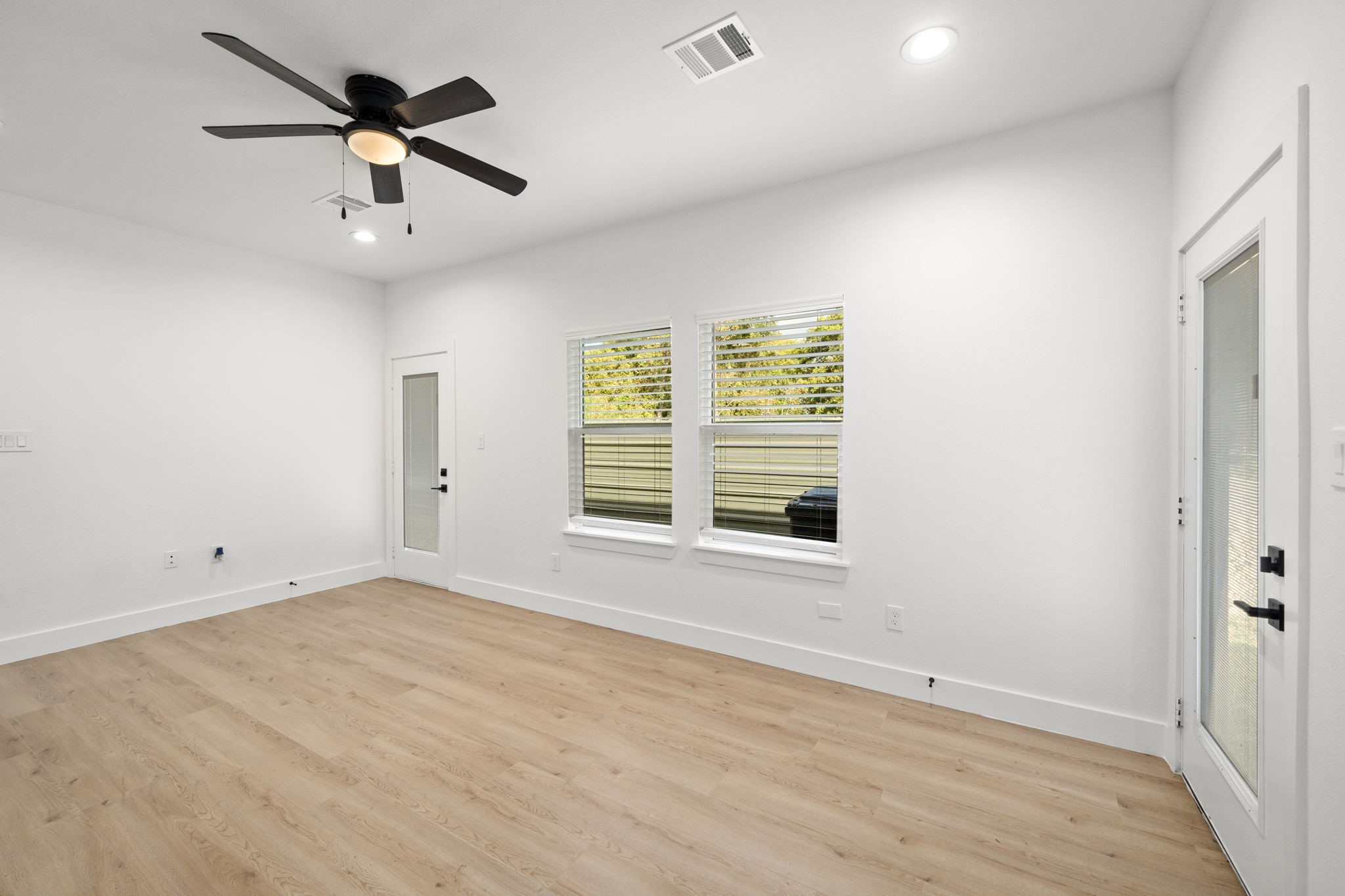 7205 Tippett Street, Unit B Houston, TX 77088 - Photo 4 of 15 wooden floor in an empty room with a window