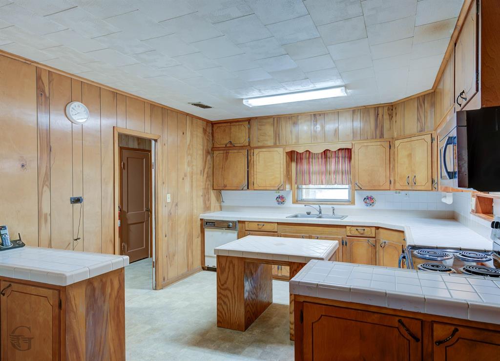 314 Dilly Road Mooringsport, LA 71060 - Photo 15 of 37 a kitchen with cabinets and outdoor view