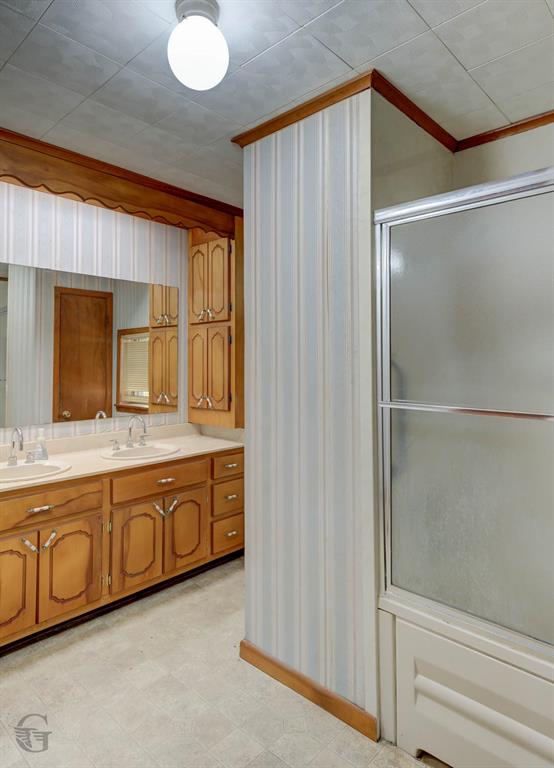 314 Dilly Road Mooringsport, LA 71060 - Photo 18 of 37 a bathroom with a double vanity sink and mirror