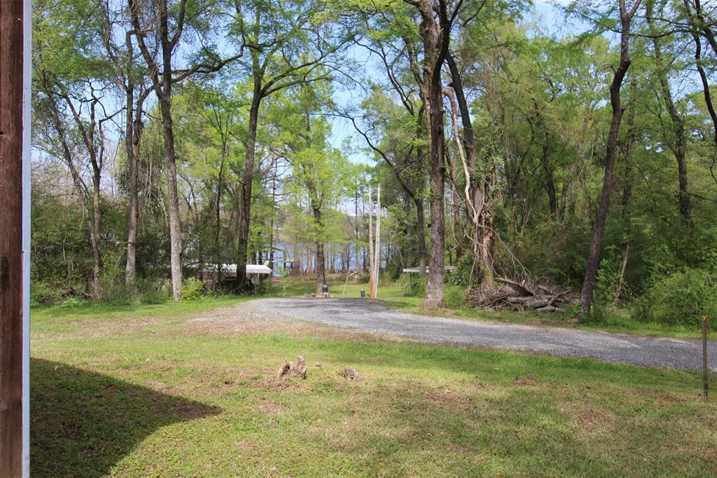 314 Dilly Road Mooringsport, LA 71060 - Photo 6 of 37 a backyard of a house with lots of green space and fountain
