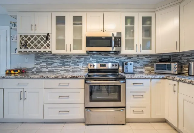 a kitchen with stainless steel appliances granite countertop a stove and a granite counter tops