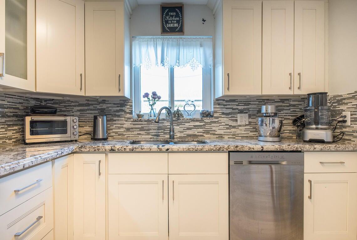 4244 Appalachian Street Boca Raton, FL 33428 - Photo 14 of 25 a kitchen with granite countertop a sink and a stove
