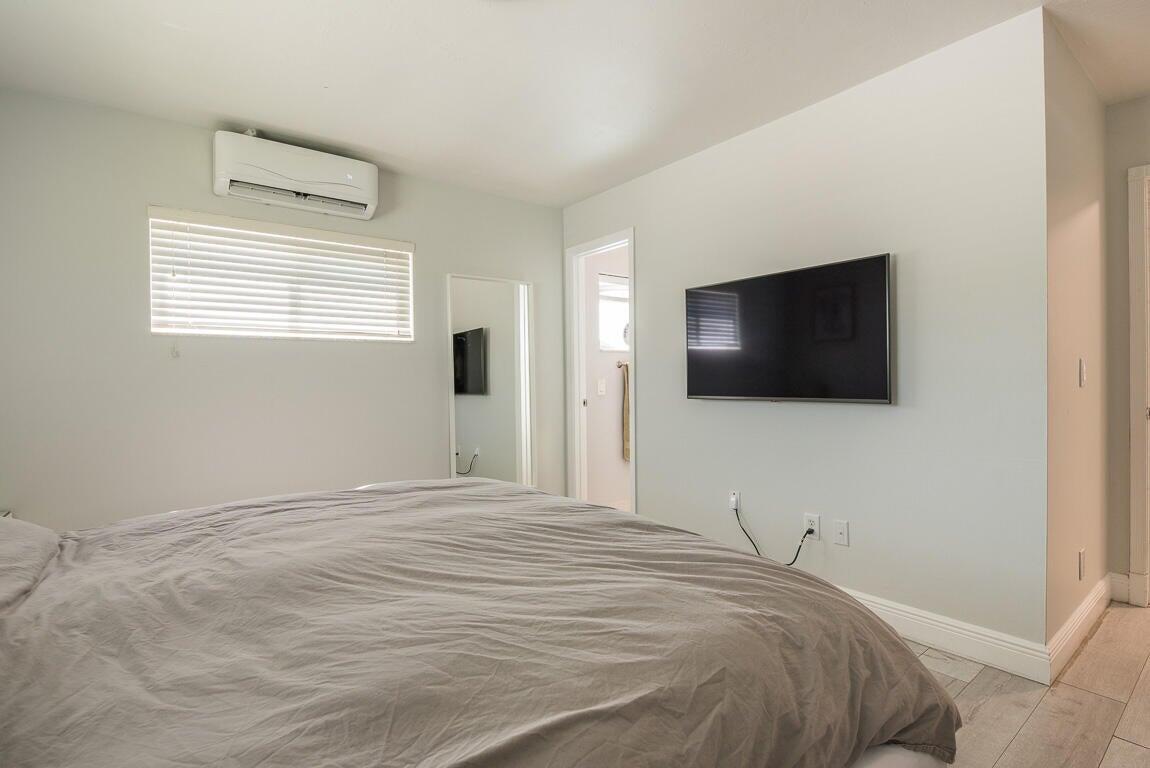 4244 Appalachian Street Boca Raton, FL 33428 - Photo 22 of 25 a bedroom with a bed and a flat screen tv