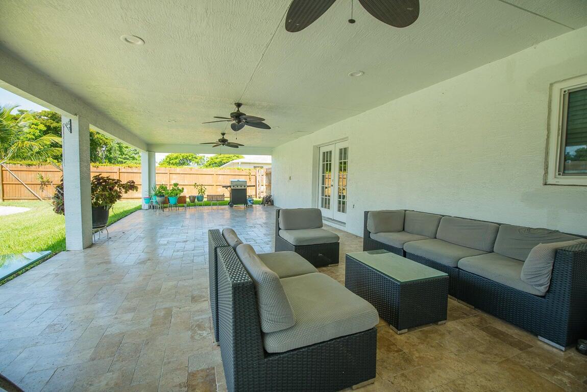 4244 Appalachian Street Boca Raton, FL 33428 - Photo 7 of 25 a living room with furniture and a large window