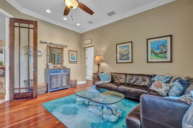 a living room with furniture and a wooden floor