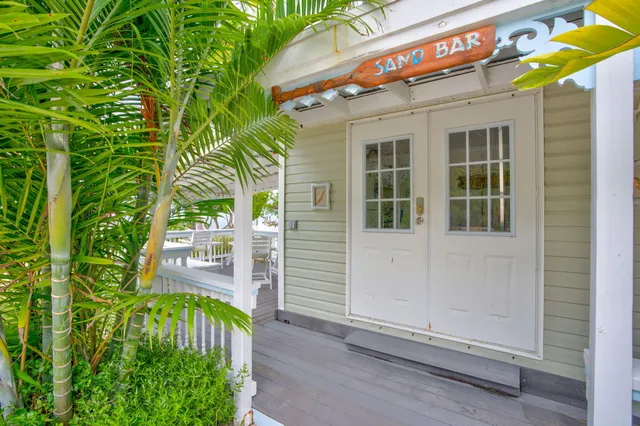 an aerial view of a house with a garden and a yard