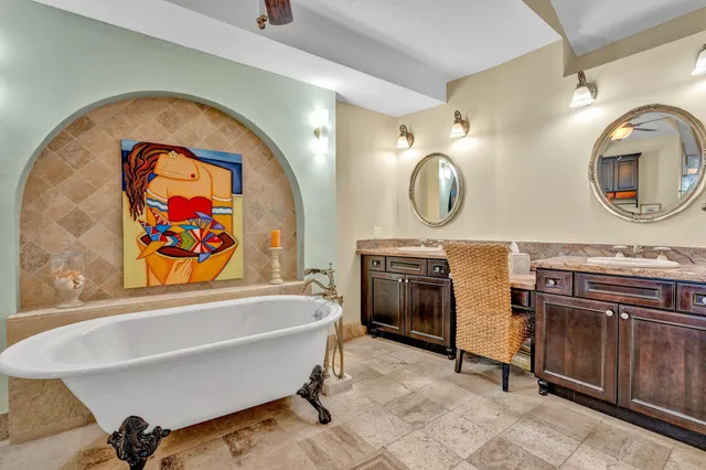 a bathroom with a sink a mirror and a bathtub