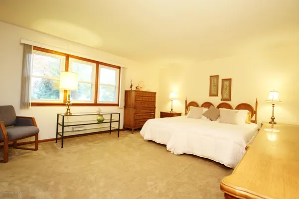 a bedroom with a bed and a night stand