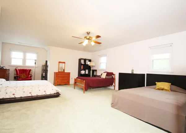a bedroom with furniture and a chandelier