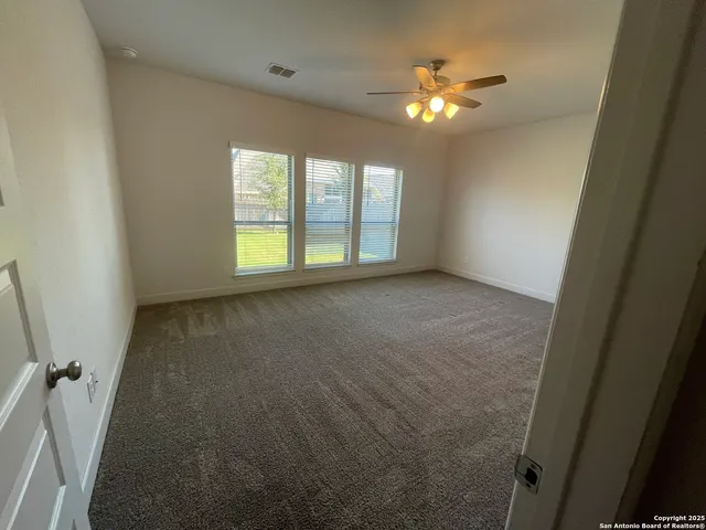 view of living room with baby crib and refrigerator