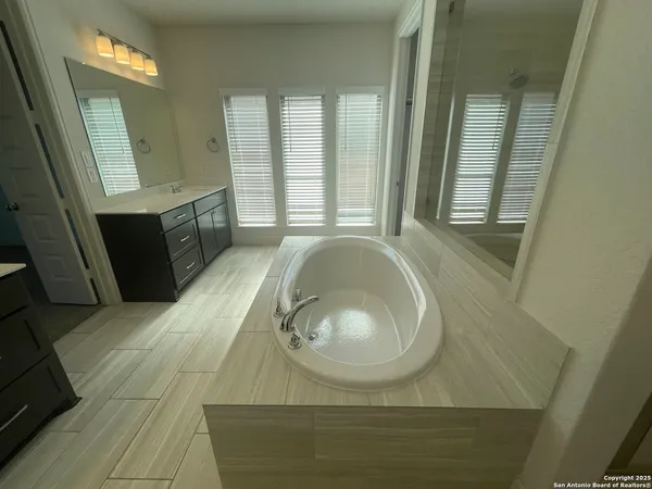 a bathroom with a glass shower door