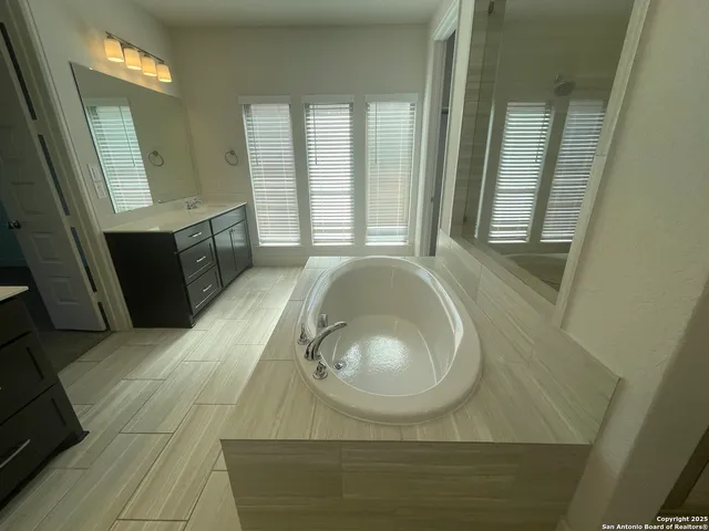 a bathroom with a glass shower door
