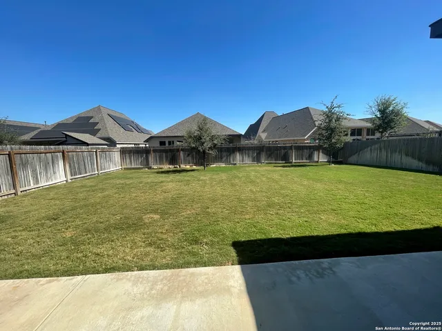 a view of a house with a yard and sitting area