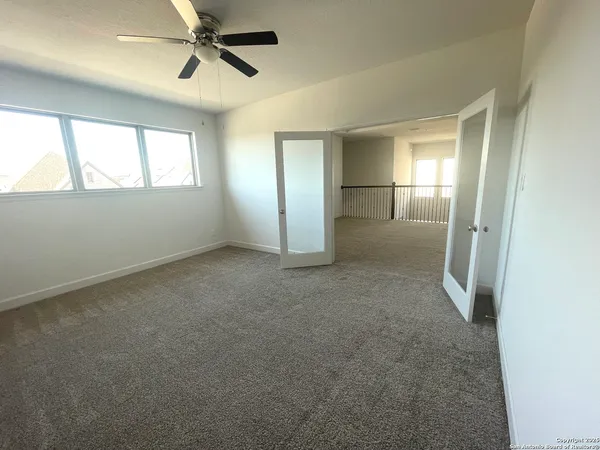 a view of a hallway with wooden floor and windows