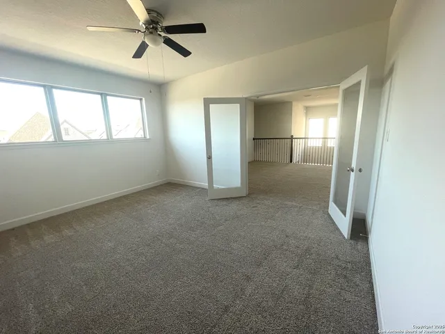 a view of a hallway with wooden floor and windows