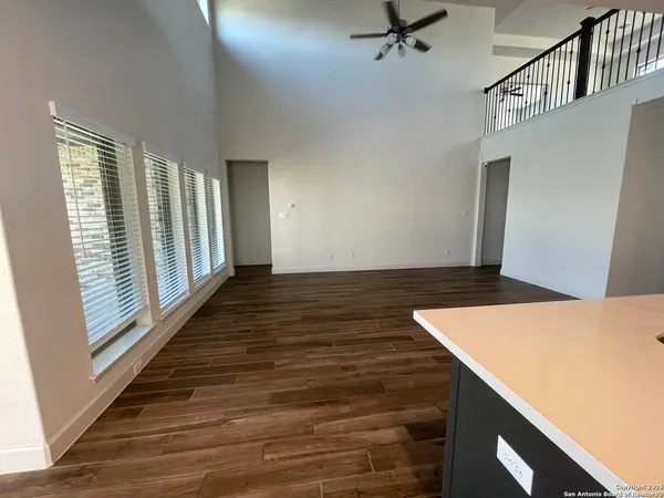 a kitchen with kitchen island granite countertop a sink window and cabinets