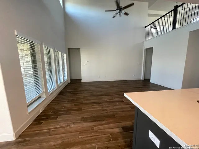 a kitchen with kitchen island granite countertop a sink window and cabinets