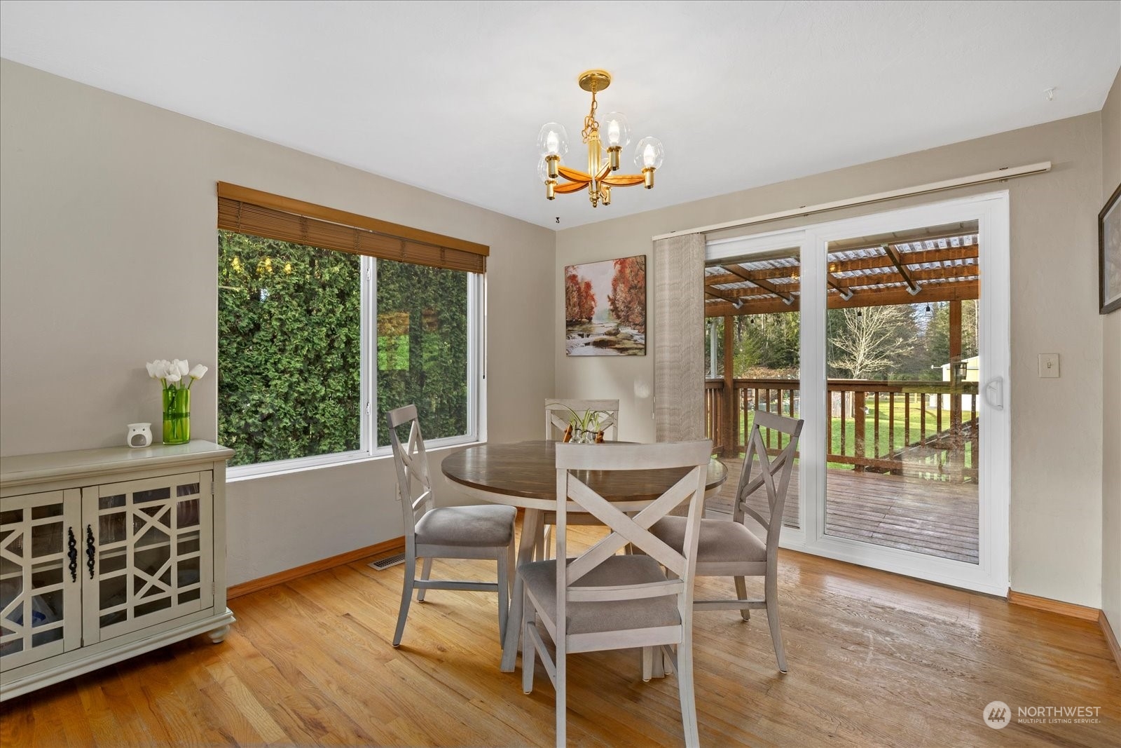 13925 Dubuque Road Snohomish, WA 98290 - Photo 11 of 40 a dining room with wooden floor a chandelier a glass table and chairs