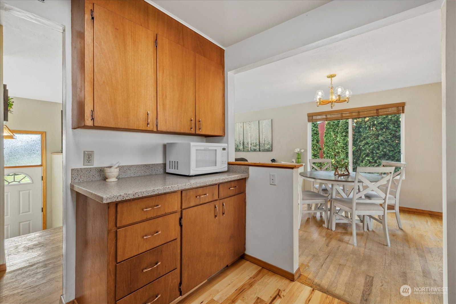 13925 Dubuque Road Snohomish, WA 98290 - Photo 15 of 40 a kitchen with a stove a sink and white cabinets with wooden floors