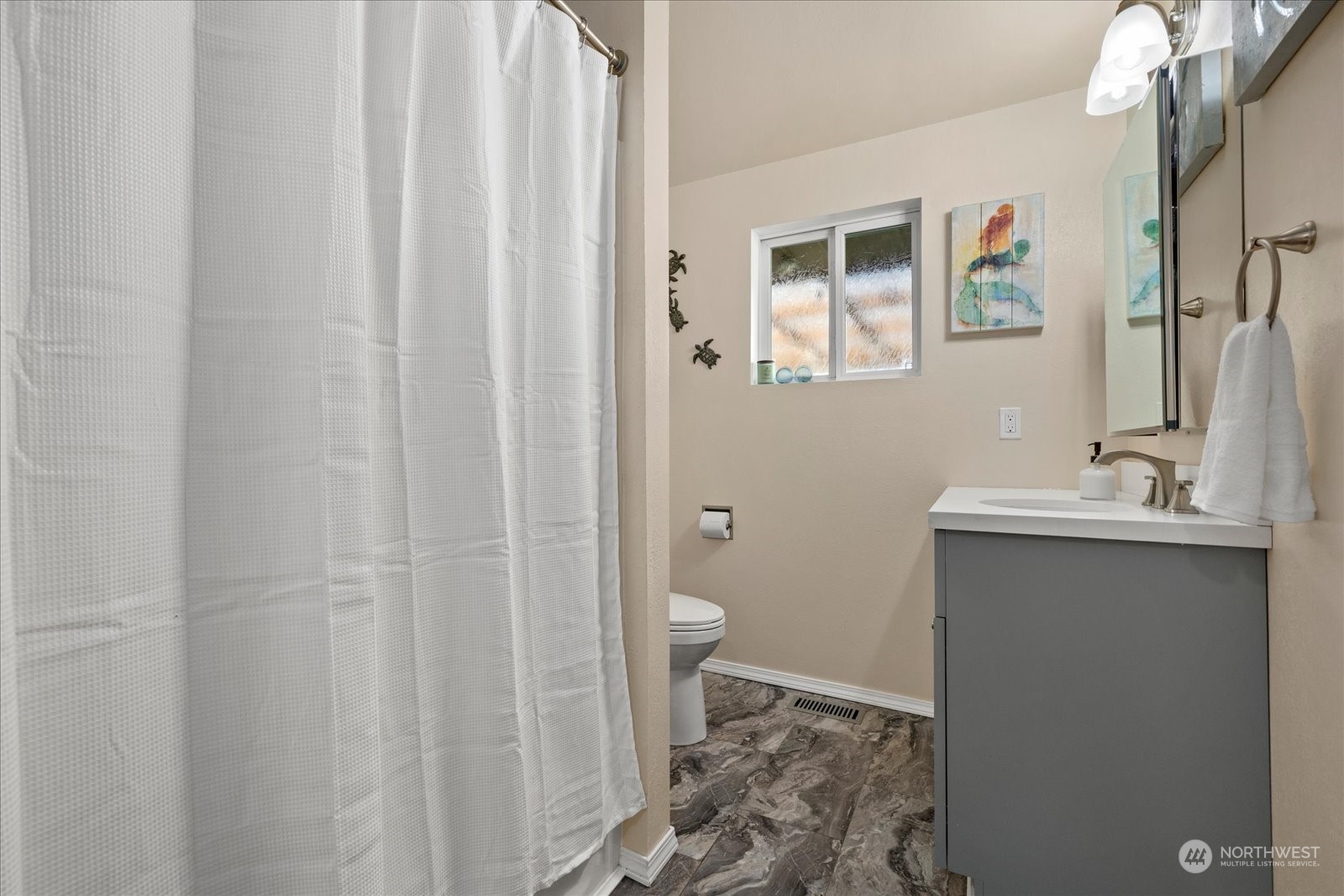 13925 Dubuque Road Snohomish, WA 98290 - Photo 19 of 40 a bathroom with a sink a toilet and shower curtain