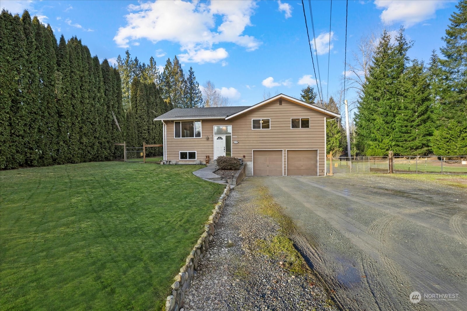 13925 Dubuque Road Snohomish, WA 98290 - Photo 4 of 40 a front view of a house with a yard and garage