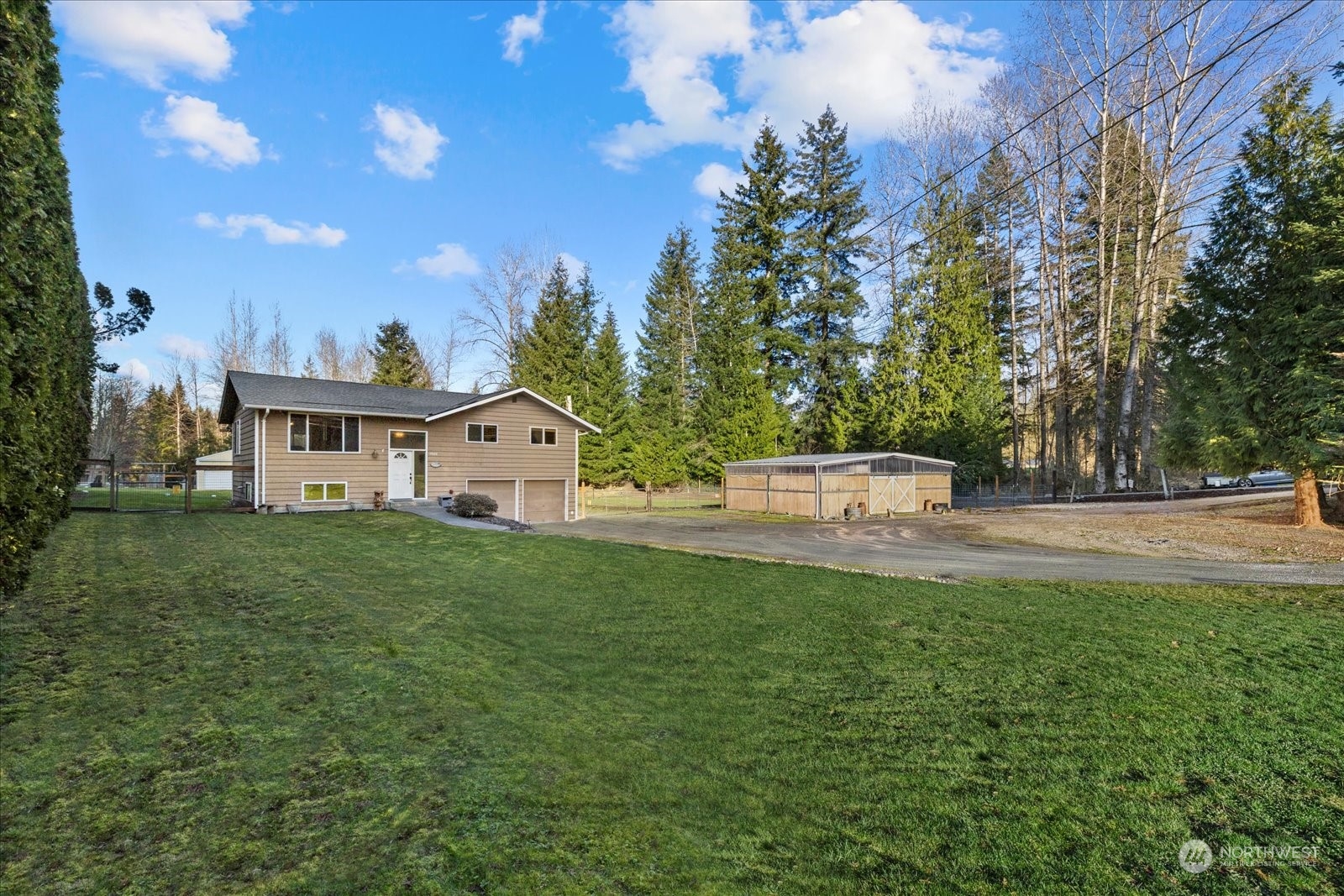 13925 Dubuque Road Snohomish, WA 98290 - Photo 5 of 40 a view of house with backyard and trees